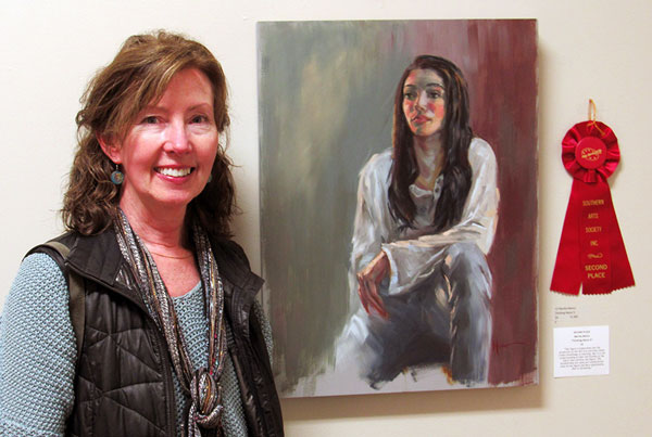 Second place winner Martha Manco with her oil painting Thinking About It.