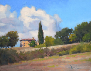 A yellow Italionate house on a Tuscan hillside under blue skies and clouds.