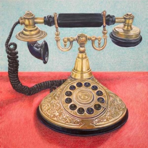 An ornate brass princess-style telephone with a round dial.