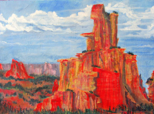 Red rock mesas against a blue and clouded sky.
