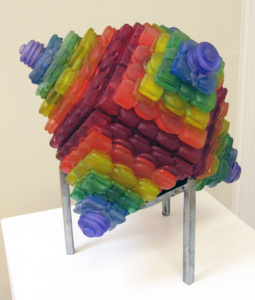 A multi-colored glass sculpture reminiscent of a terraced spinning top.