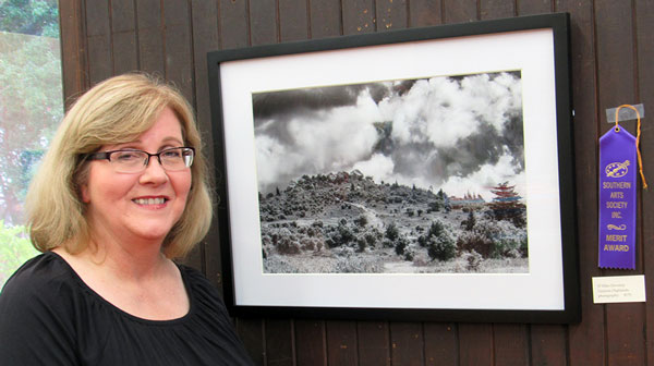 Ellen Devenny and her merit award winning photography at Southern Arts Society reception.