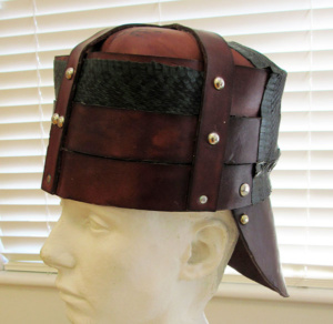 A triple-piece leather helmet fastened by silver metal studs.