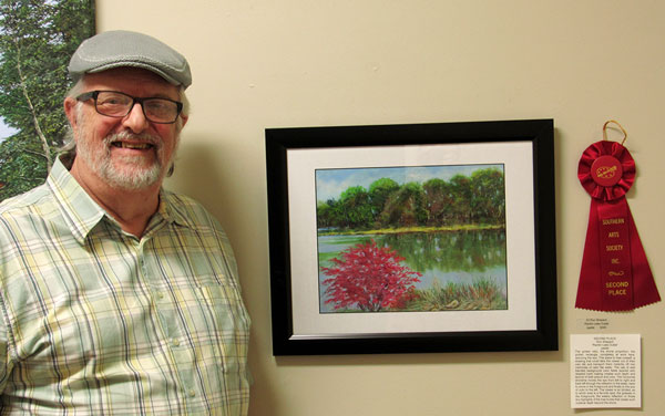 Artist Ron Shepard with his artwork for Nature Reconsidered 2022 exhibit at Southern Arts Society.