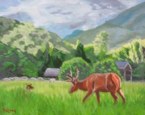 an elk grazing in a mountain clearing with a barn and farmhouse against a background of mountains.