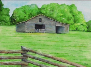 an old still functioning grey barn in a green field.