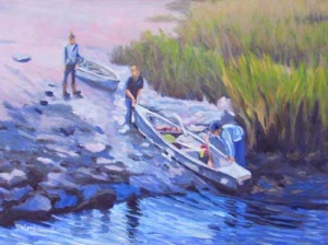 3 people sliding their kayaks down a bank into the water.