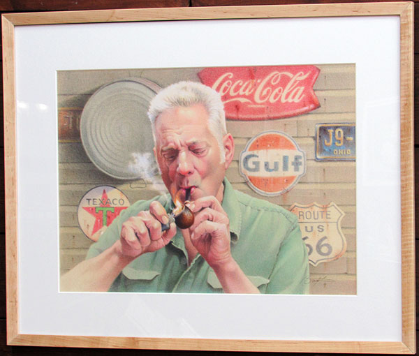 Todd Baxter's color pencil drawing of a white haired man lighting a pipe as smoke whisps against a background of antique metal gas station signage.
