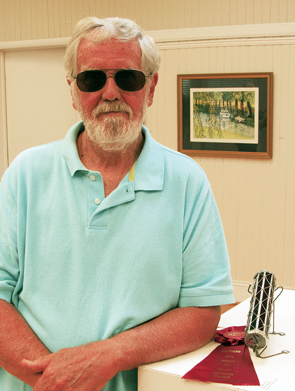 Artist Robert Silver next to hos winning stained glass kaleidoscope viewer.