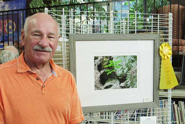 Alex Pietersen with his photo of a plant growingon tough rocks, Tough Enough