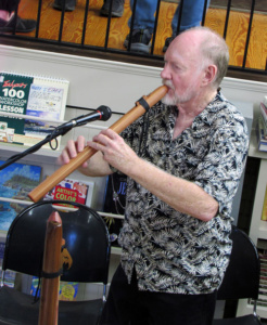 musician Hoyt Taylor playing a wooden flute