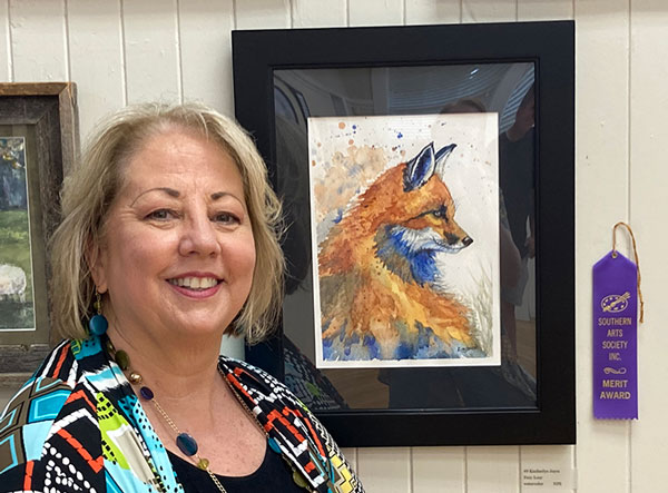 Artist Kimberlye Joyce with her merit award-winning artwork.