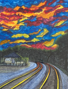 Vibrant night sly above a train depot with a sign saying ART.
