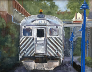 a modern steel train at a train station.