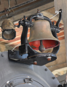 Up close photography of an string-pulled old train bell.