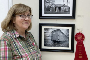 Ellen Devenney with her second place black and white photo of a single train box car.
