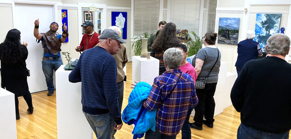 a group of visitors enjoying the exhibit at Southern Art Society's Reavis Gallery