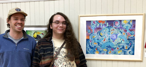 artists Noah Huntley and Tyler Fuentes next to Fuentes' second place artwork