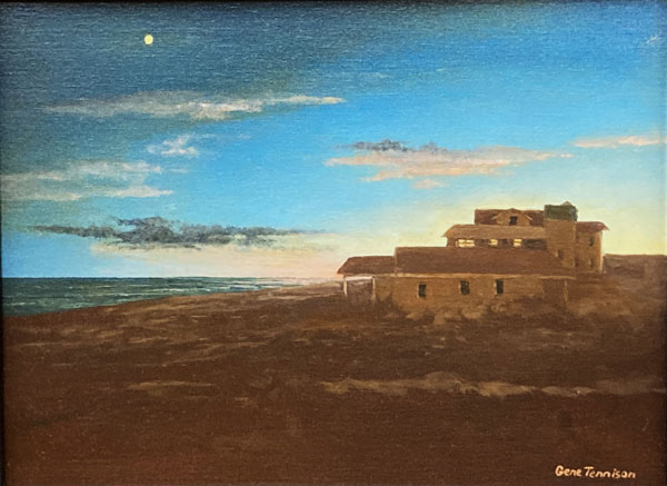 Sun setting with water in the distance behind a brown hill with a lone house.