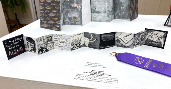 A black and white accordian-folded booklet of images and text.