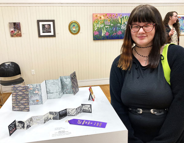 Artist Taylor Stump with her artwork.