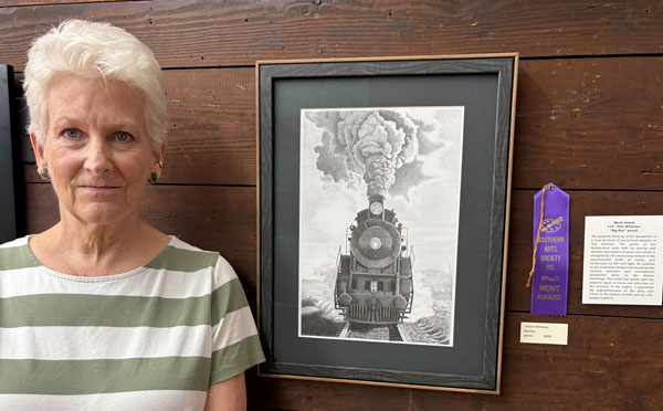 artist Erin Whitener with her merit award artwok.