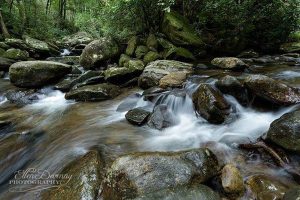 water rushing over rocks photography