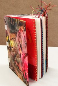 Hand-covered, hand-bound, and hand-stitched art book with colorful loose threads by Sandy Mason