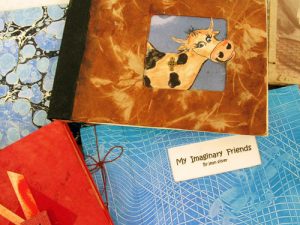 art books with hand-made covers, one with a cow, by Jean Silver