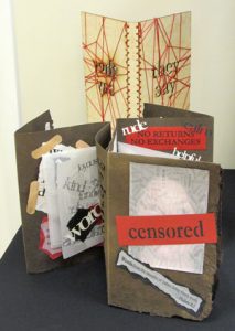 Hand made accordion style art books - one featuring censored as a title by Lore Spivey