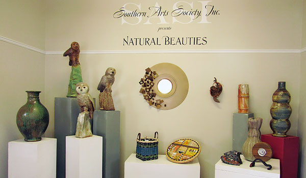Entryway to Southern Arts Spciety Natural Beauties exhibit featuring natural potteries and bird-haped statues.